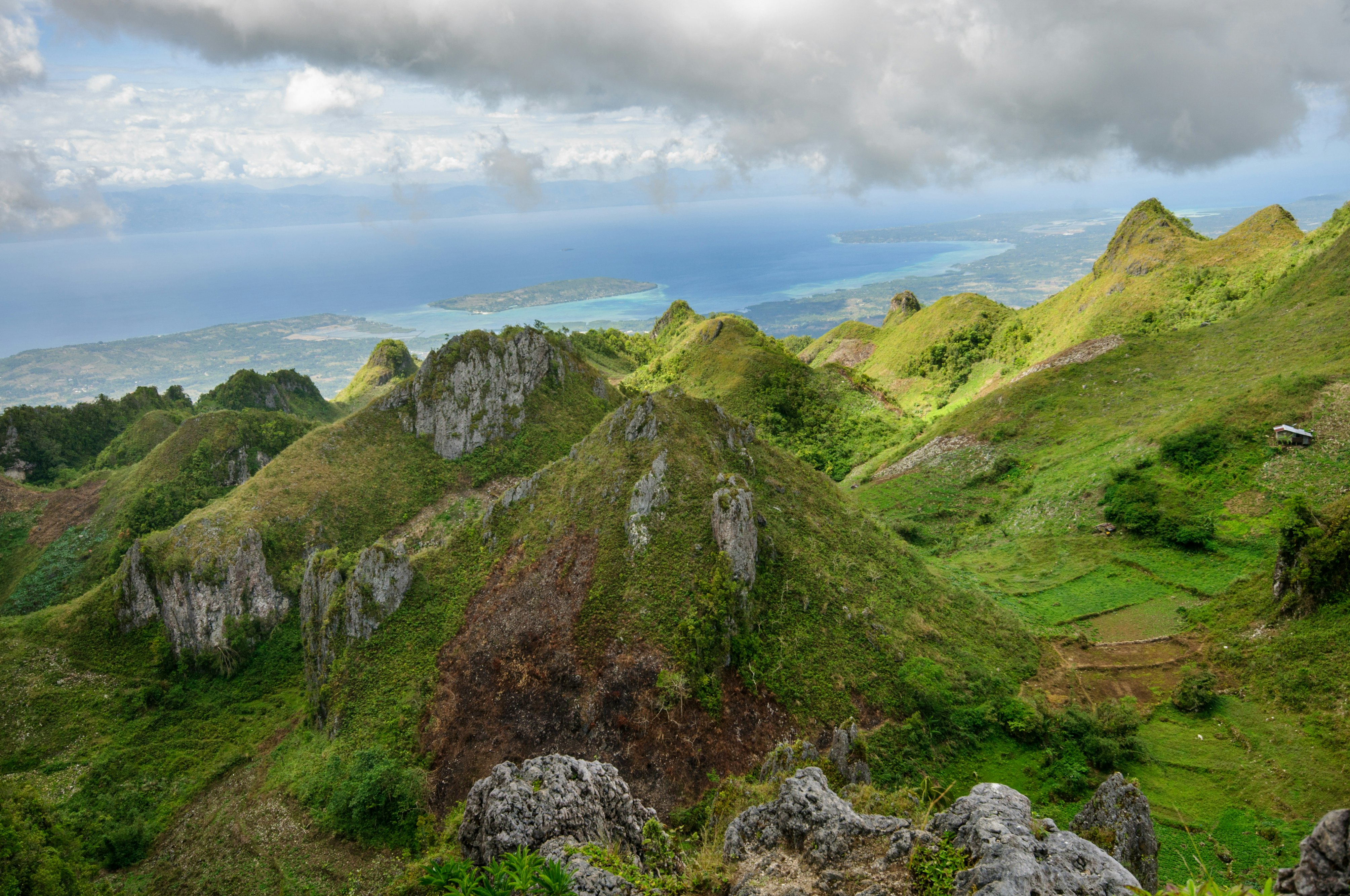 green and brown mountain under white clouds during daytime